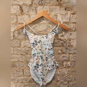 One piece swimsuit. Baby blue, floral print.  Crisscross back and side cut outs